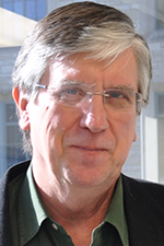 Headshot of Prof. Bedzyk lit from the left side with a window in the background